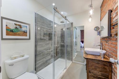 a bathroom with a shower and a toilet and a sink at Le 555 Grande allée in Quebec City