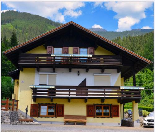 a building with a bench in front of it at Zugspitzhaus Monika in Lermoos