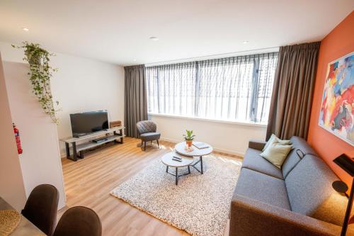 a living room with a couch and a table at Trendy Design 55m2 Apartment with Balcony - DB6B in Den Bosch