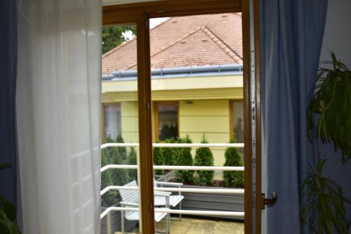 a sliding glass door with a view of a balcony at STM3 Apartman in Pécs