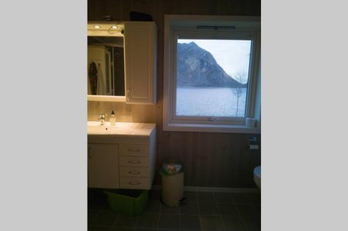 a bathroom with a sink and a window at Ro i Steigen in Steigen