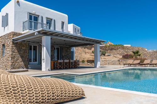 a villa with a swimming pool and a house at Carpe Diem Villas Mykonos ,Heated Pool! in Ornos