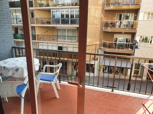 a balcony with a table and chairs and a building at Frontimar in Calpe