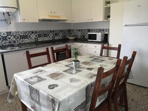 a kitchen with a table with a table cloth on it at Piso da Horta en Aguiño, Ribeira, Galicia in Ribeira