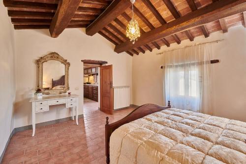 a bedroom with a bed and a vanity and a mirror at La Rosa in Città di Castello
