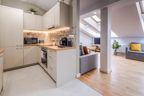 an open kitchen and living room in an apartment at Old Town Vistula Premium Apartments in Kraków