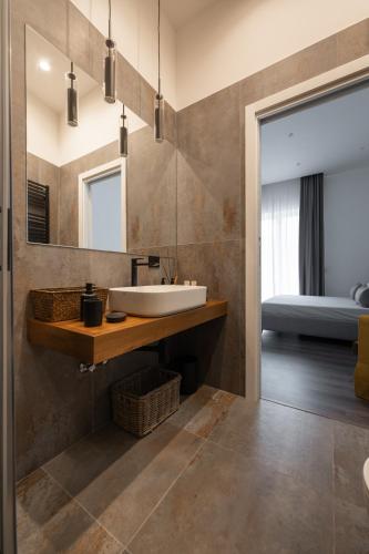 a bathroom with a sink and a mirror at Harmony Luxury Rooms in Castellammare di Stabia