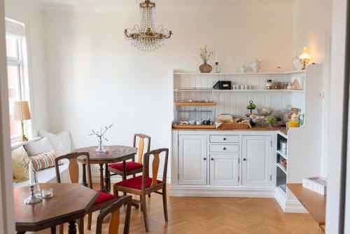 a kitchen with a table and a dining room at Prästgårdens Pensionat in Mollösund
