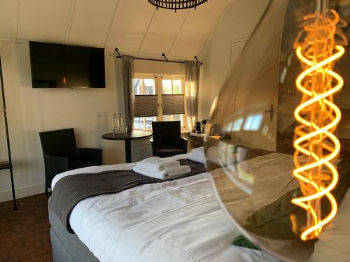 a bedroom with a bed with a lighted at Bed and Breakfast Goes in Goes
