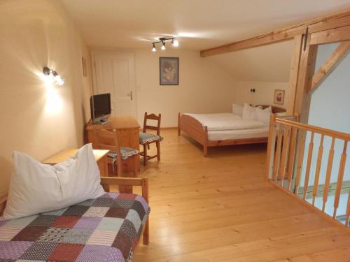 a room with a bed and a living room at Attersee Gartenvilla in Nussdorf am Attersee