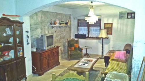 a living room with a couch and a table at Apartment in Zlarin with balcony, W-LAN, washing machine (3813-2) in Zlarin