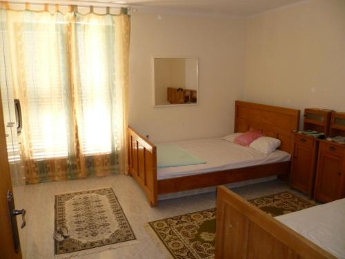 a small bedroom with a bed and a window at Apartment in Zlarin with balcony, W-LAN, washing machine (3813-2) in Zlarin