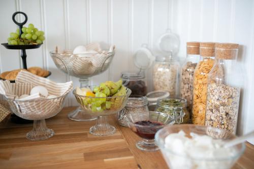 a table topped with bowls of food and other foods at Prästgårdens Pensionat in Mollösund