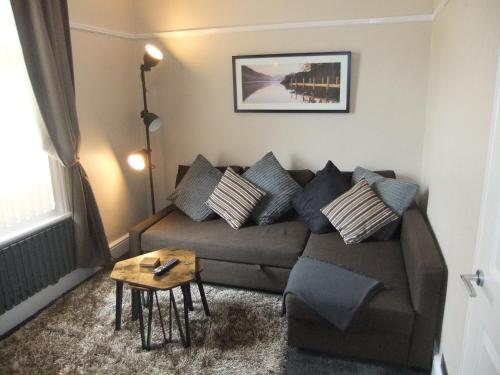 a living room with a couch and a table at Dewsbury House in Blackpool