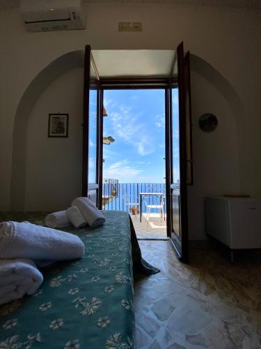 a bedroom with a bed with a view of the ocean at Residenza Porta di Mare in Castellabate