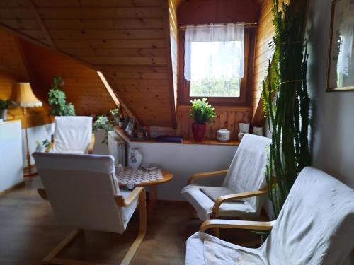 a room with two chairs and a table and a window at Anna vendégház in Tihany