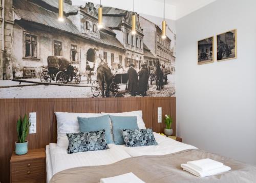 a bedroom with a bed with a black and white photo on the wall at Starowislna 77 in Kraków