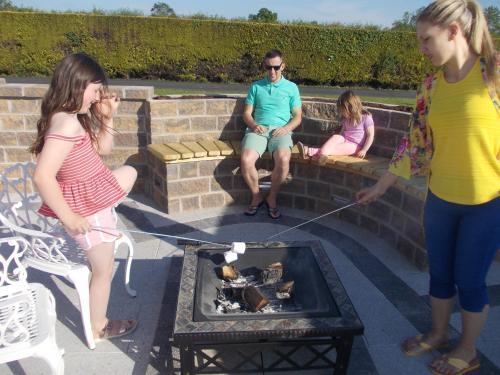 a group of people standing around a fire pit at Glendaloch B&B in Antrim
