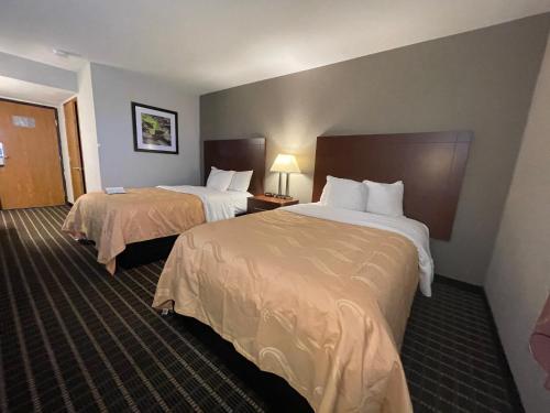 a hotel room with two beds in a room at Quality Inn Madison West Near University Area in Madison
