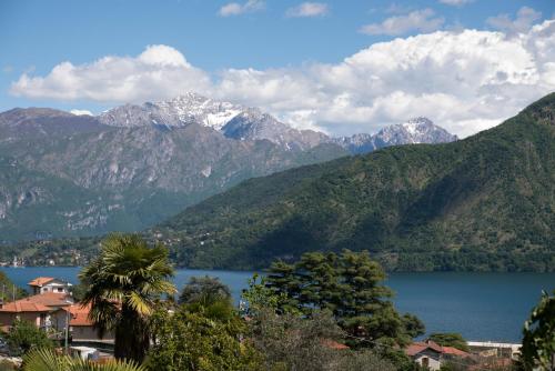 a view of a mountain range with a lake at Mansarda I Cipressi in Lenno