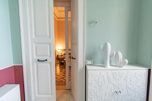 a room with a refrigerator with two rabbits on top of it at Hotel Belami in Maglie