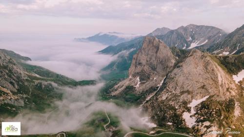 a view of a mountain range with clouds in the valley at B&B Ca' Mea room, wellness & food in Levata