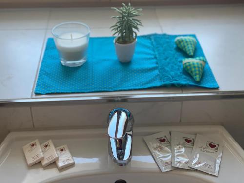 a sink with a glass of milk and a potted plant at Ferienwohnung Natururlaub Muggenbrunn in Todtnau