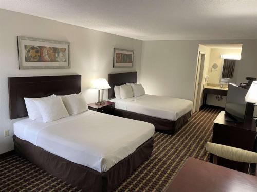 a hotel room with two beds and a television at Best Western of Clewiston in Clewiston
