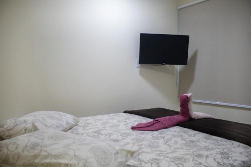 a pink stuffed animal sitting on top of a bed at Chalé Ribeirão do Meio in Lençóis