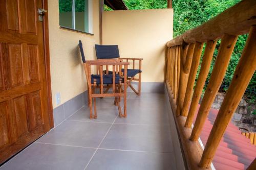 a porch with a table and chairs on it at Chalé Ribeirão do Meio in Lençóis