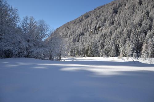 a snow covered lake in front of a mountain at Alle pendici del Monte Rosa in Champoluc
