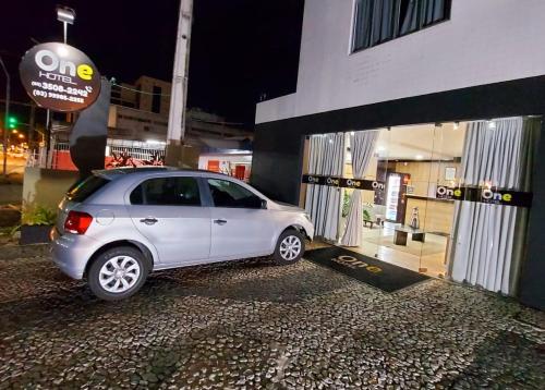 a white car parked in front of a building at One Hotel in João Pessoa