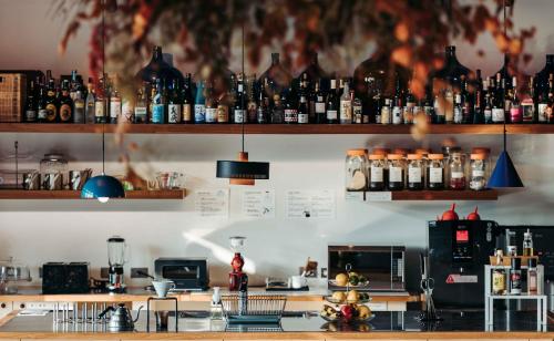 a bar with a lot of bottles on the wall at U.I.J Hotel & Hostel in Tainan