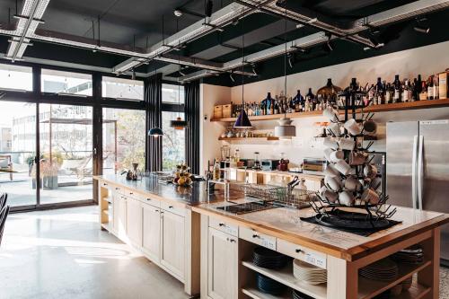 a large kitchen with a large counter and a large window at U.I.J Hotel & Hostel in Tainan