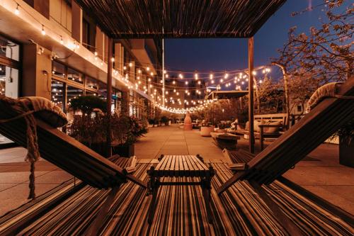 a bench sitting in front of a building with lights at U.I.J Hotel & Hostel in Tainan