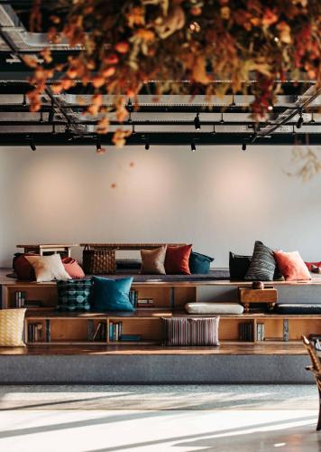 a room with couches and pillows at U.I.J Hotel & Hostel in Tainan