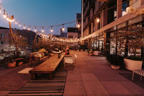 a patio with benches and lights on a building at U.I.J Hotel & Hostel in Tainan