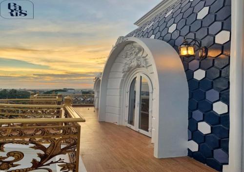 a balcony of a building with a tile wall at Paris Hotel Bình Thuận in Tuy Phong