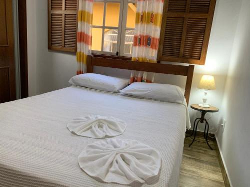 Ένα ή περισσότερα κρεβάτια σε δωμάτιο στο Pouso da Ju