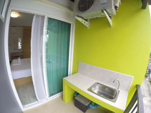 a small bathroom with a sink and a window at Shyne Place in Phuket