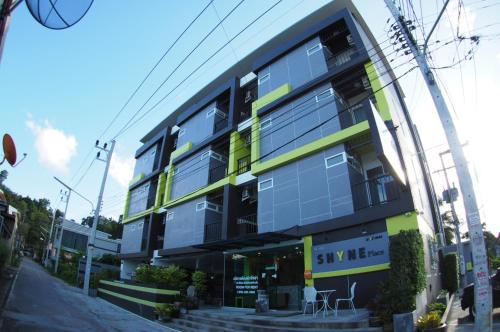a building on a city street with a building at Shyne Place in Phuket Town