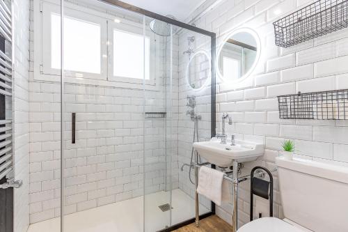 a white bathroom with a sink and a shower at FIRST LINE SEA VIEWS - Club & Pool & Parking by ALOHA Bilbao in Sopelana