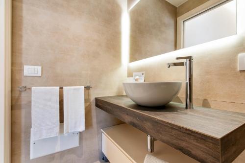 a bathroom with a bowl sink on a wooden counter at Palazzo San Lazzaro - Jacuzzi Rooms & Suites Lecce Selection in Lecce