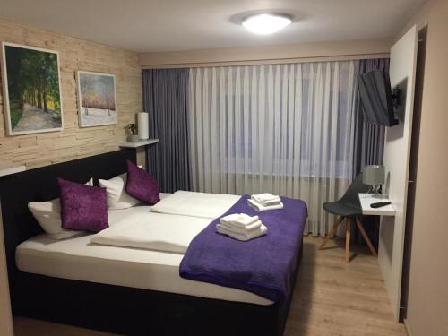 a hotel room with a bed with towels on it at Landgasthof Ochsen in Wutöschingen