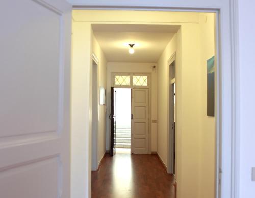 a hallway with white walls and a door at B&B Il Sole Blu in Trapani