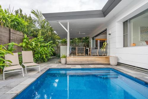 a swimming pool in the backyard of a house at Kaylani Beach House 1 in Byron Bay