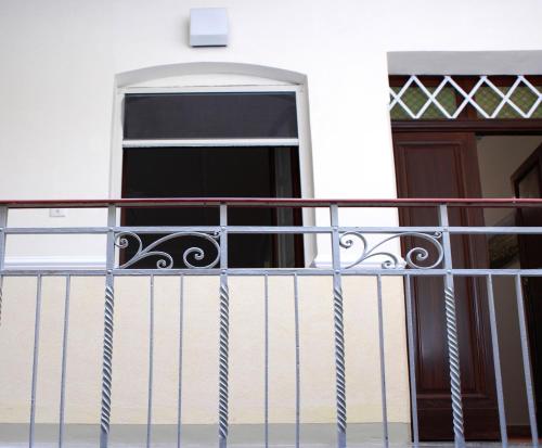 a balcony with a gate and a door at B&B Il Sole Blu in Trapani