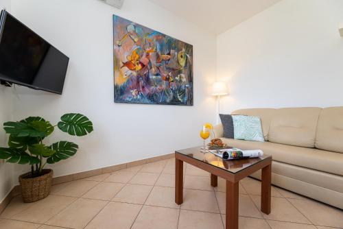 a living room with a couch and a table at Happy Apartments Baška in Baška