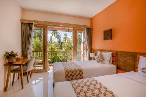 a hotel room with two beds and a desk and a window at Kahayana Suites Ubud in Ubud