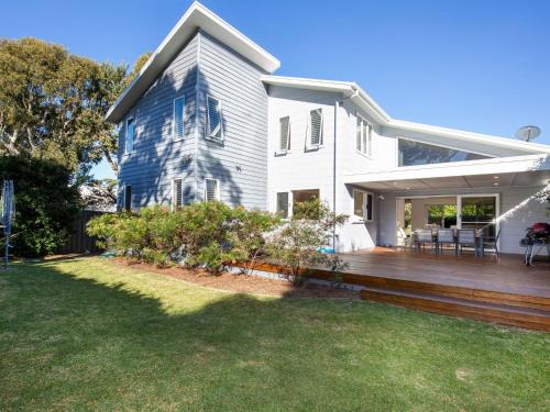 a house with a wooden deck in the yard at Sapphire Sands - Pet Friendly - Community Pool in Callala Beach